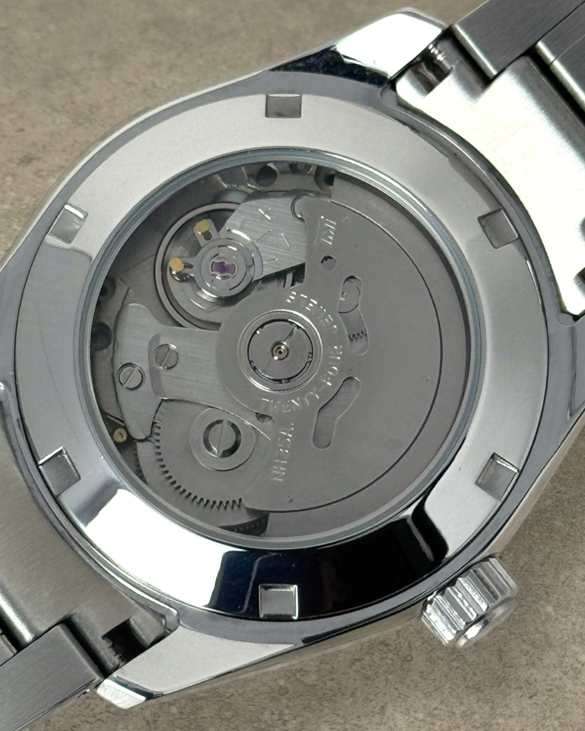 PB TimePiece Heritage watch showing the exhibition case back with Seiko NH35 automatic movement and steel bracelet