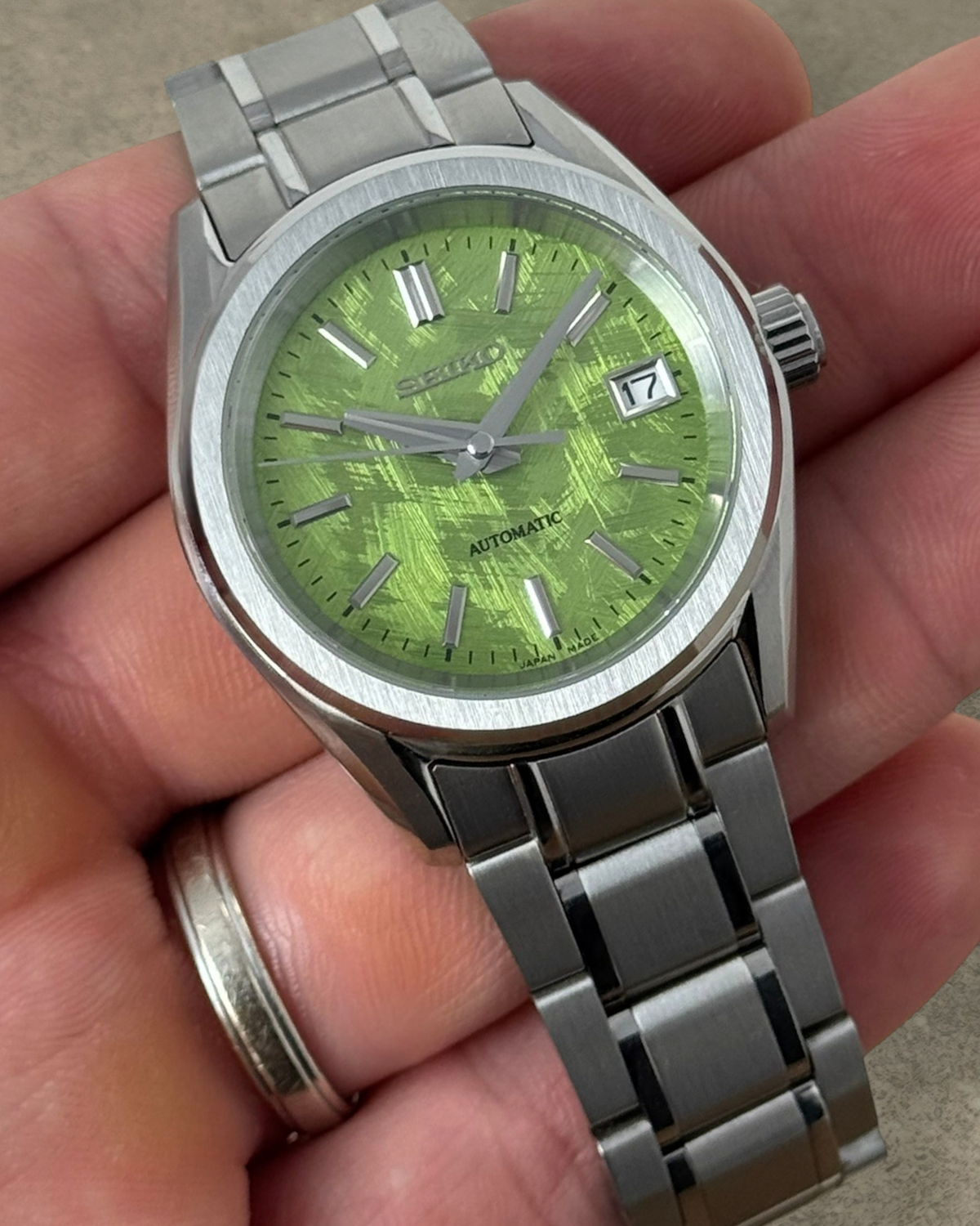 PB TimePiece Heritage watch with a pistachio green textured dial, stainless steel case, and matching metal bracelet.