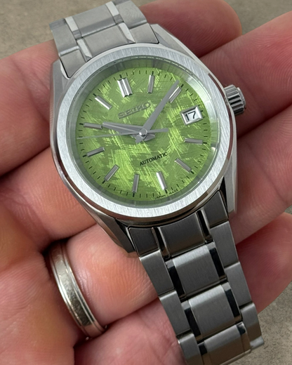 PB TimePiece Heritage watch with a pistachio green textured dial, stainless steel case, and matching metal bracelet.