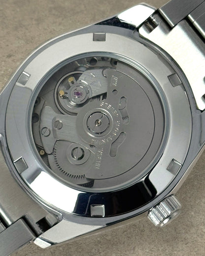PB TimePiece Heritage watch exhibition case back showing the automatic Seiko NH35 movement inside a steel case
