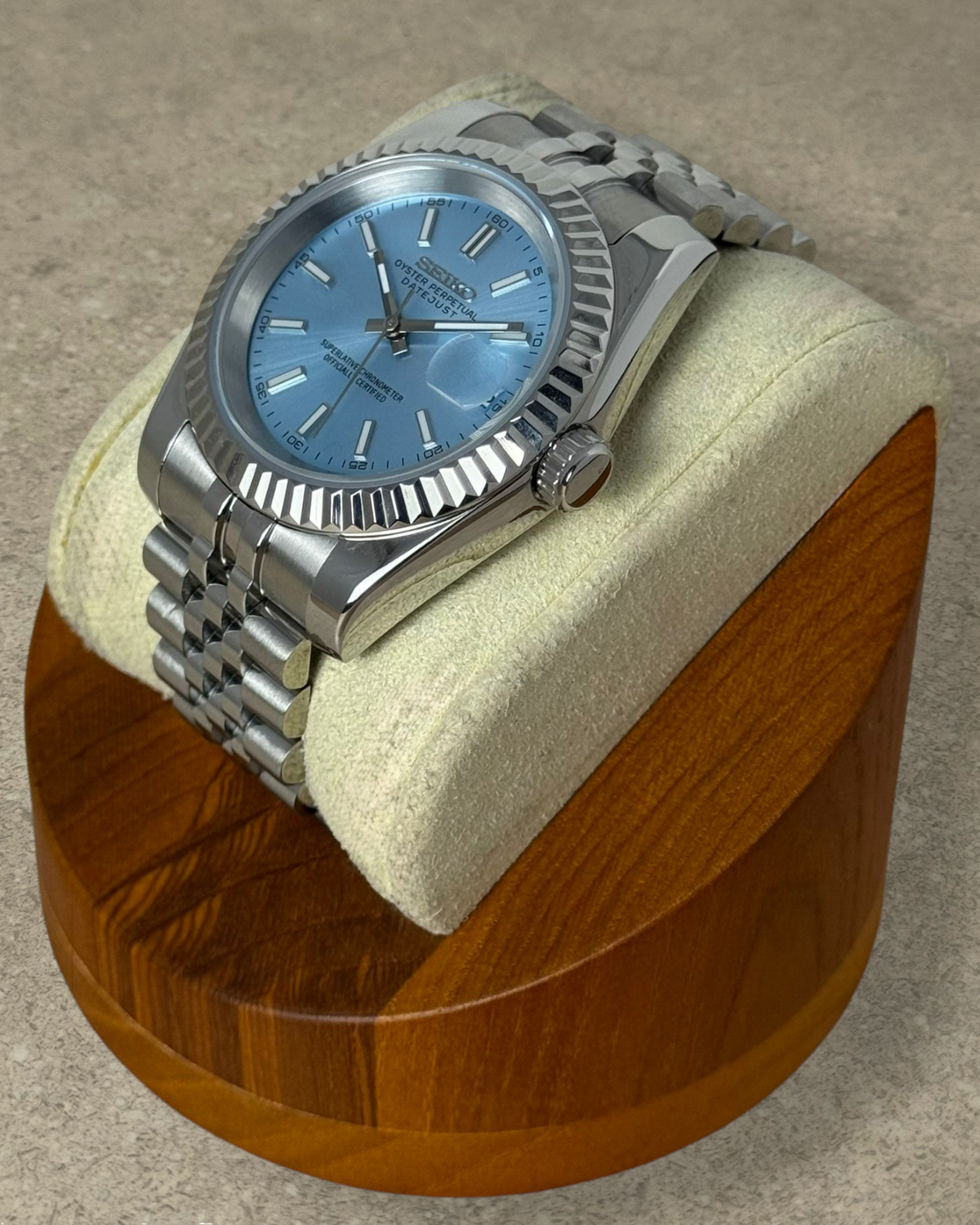 PB TimePiece Classic Date watch with ice blue dial, stainless steel jubilee bracelet, and fluted bezel on display.