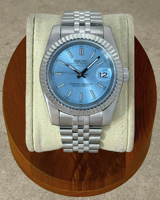 PB TimePiece Classic Date watch with ice blue dial, stainless steel jubilee bracelet, and fluted bezel.