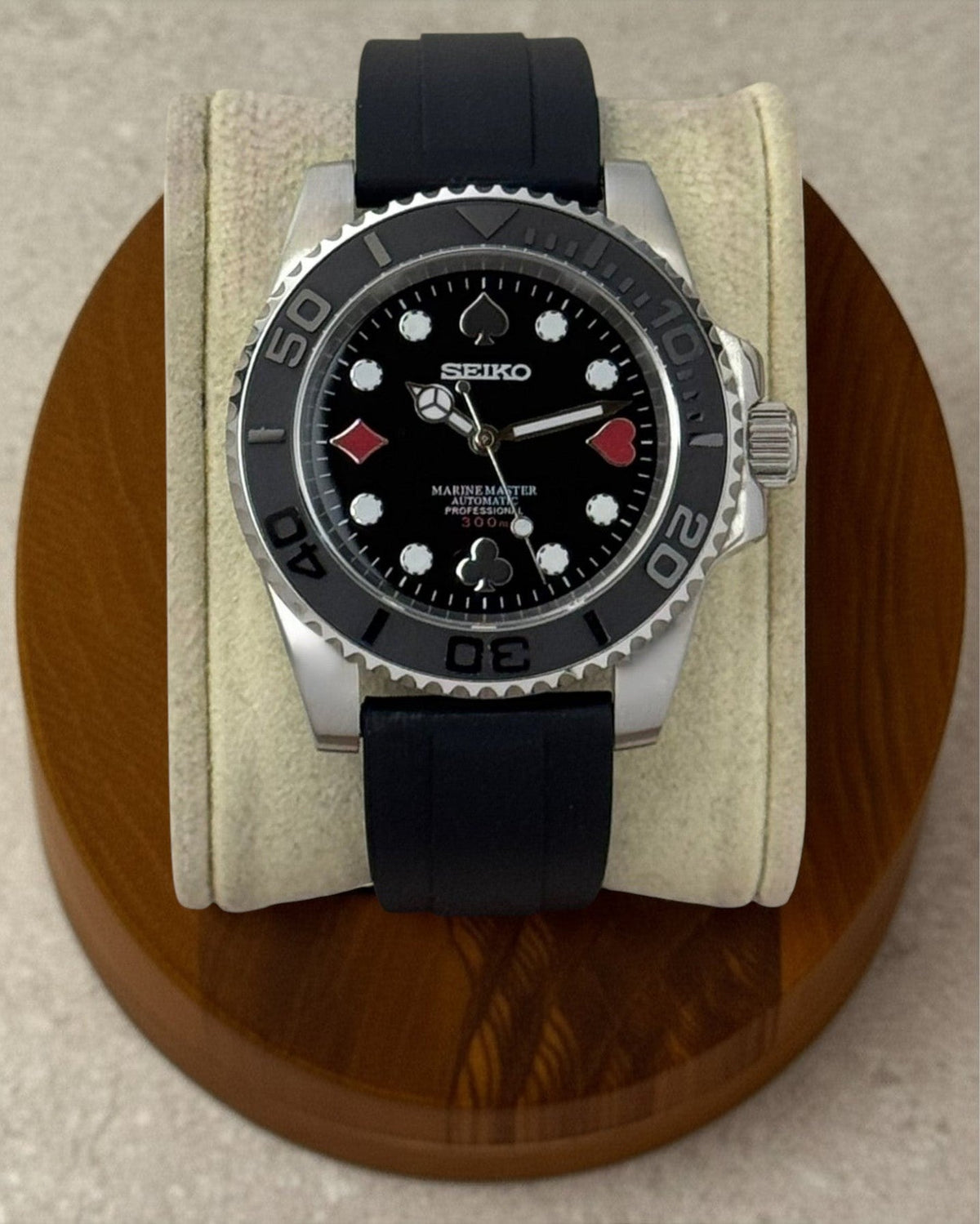 PB TimePiece Marinemaster Poker Face watch with a black dial, stainless steel case, and black rubber strap.