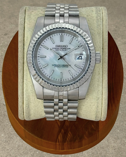PB TimePiece Classic Date watch with a mother of pearl dial, stainless steel jubilee bracelet, and fluted bezel.