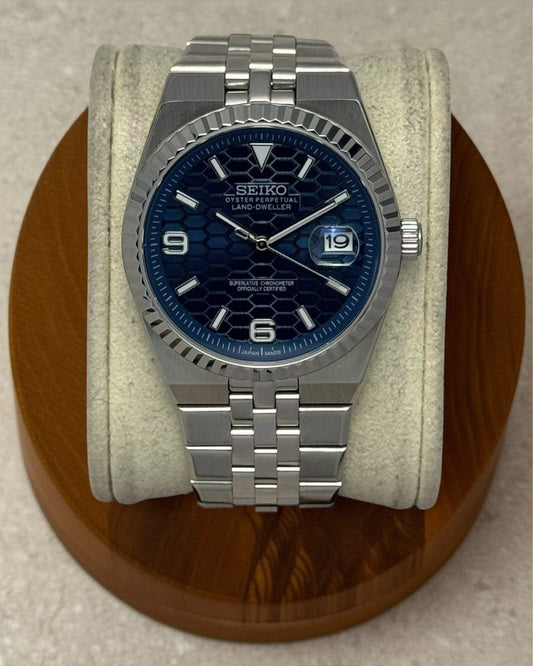 PB TimePiece Honeycomb navy blue watch with stainless steel jubilee bracelet, fluted bezel, and sapphire crystal.