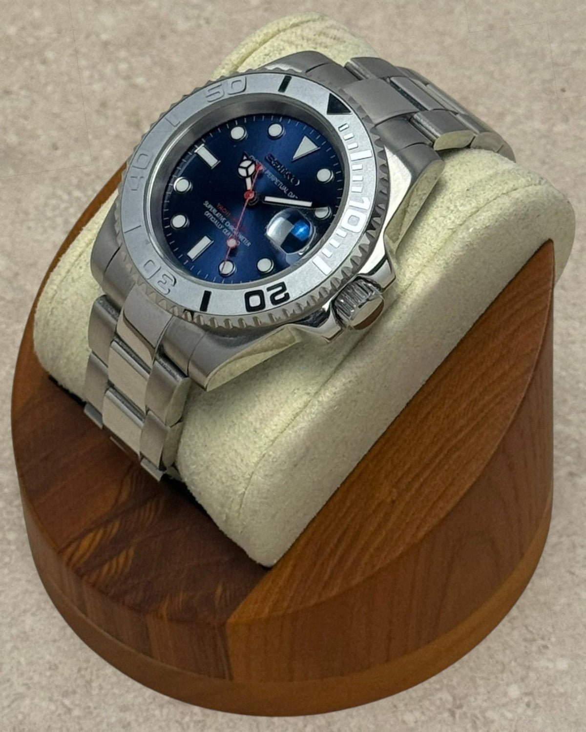PB TimePiece Yachtmaster watch with navy blue dial, stainless steel oyster bracelet, and rotating matte gray bezel.