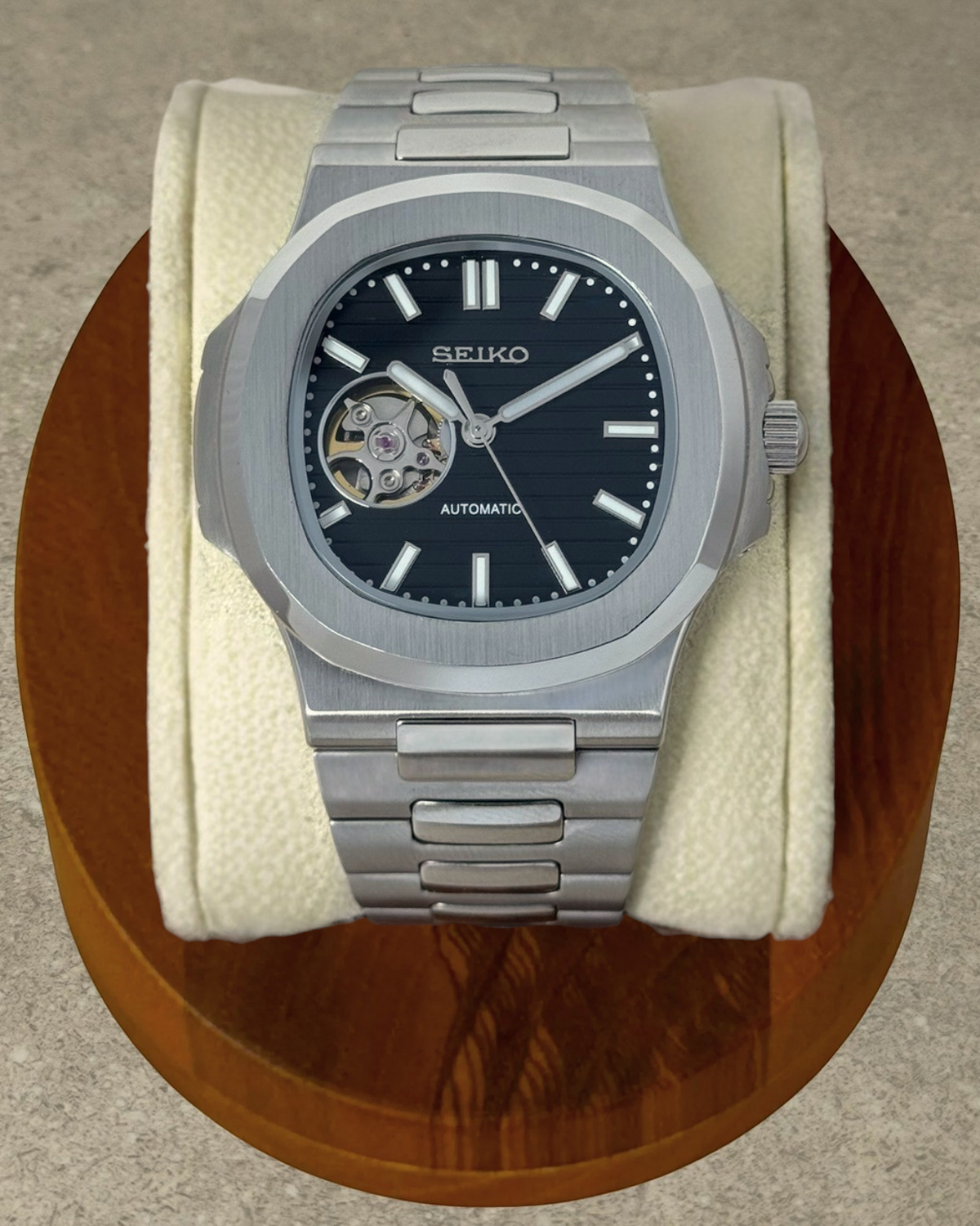PB TimePiece Novara automatic watch with a black open heart dial, stainless steel case, and brushed bracelet.