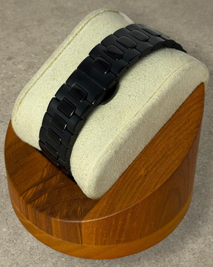 PB TimePiece Novara watch featuring a black stainless steel bracelet with a butterfly clasp on a display stand.