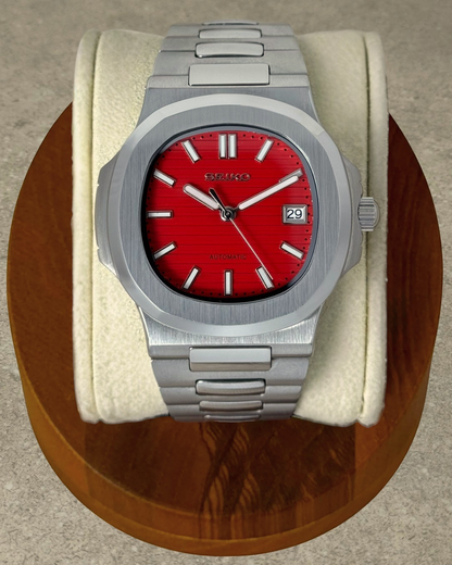 PB TimePiece Novara watch with a textured crimson red dial, stainless steel case, and integrated bracelet.