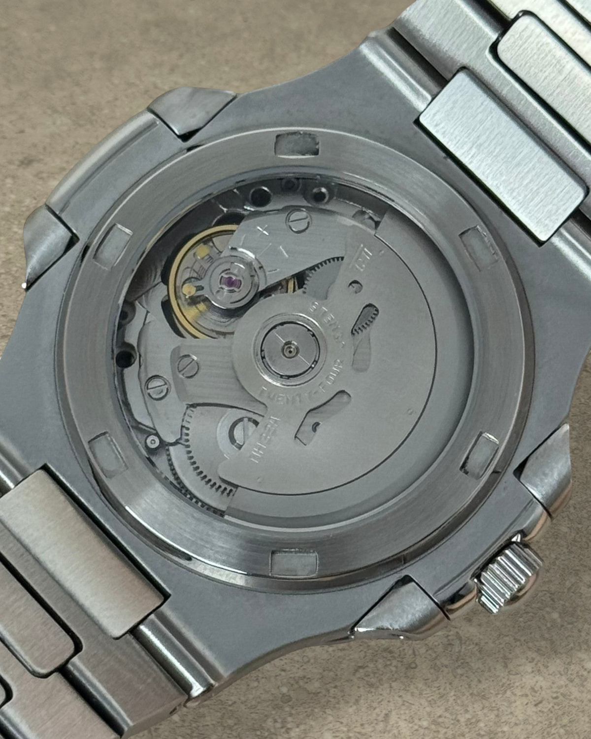 PB TimePiece Novara watch exhibition case back showing the automatic Seiko NH35 movement and stainless steel bracelet