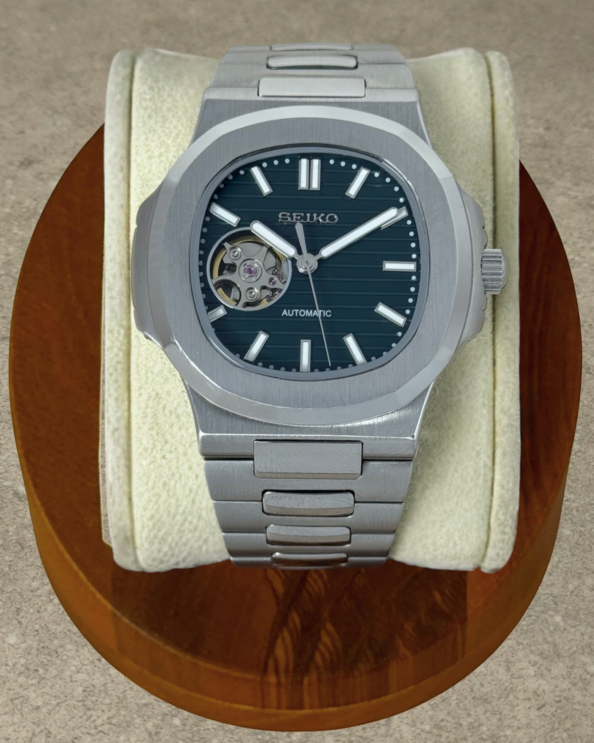 PB TimePiece Novara automatic watch with a forest green open heart dial, stainless steel case, and bracelet.