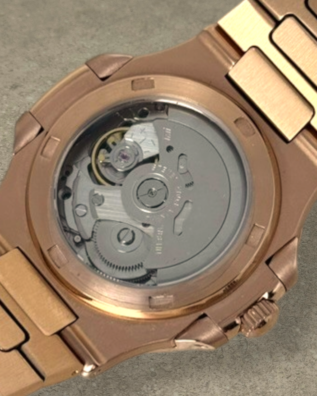 PB TimePiece Novara rose gold stainless steel watch showing the automatic Seiko NH70 movement through the case back