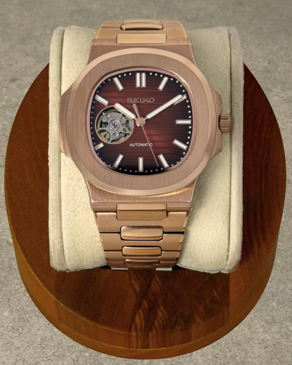 PB TimePiece Novara rose gold automatic watch with a chocolate open heart dial and stainless steel bracelet.