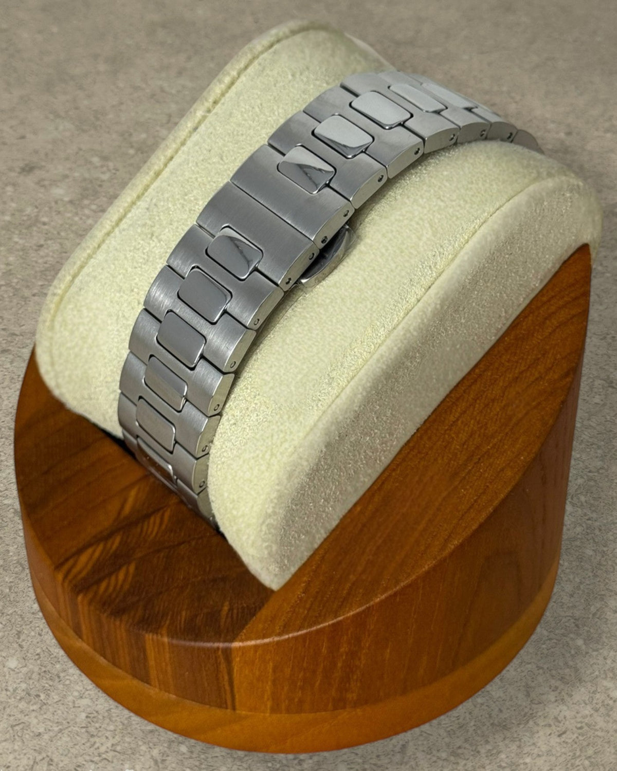 PB TimePiece Novara watch featuring a brushed stainless steel bracelet with a butterfly clasp on a display stand