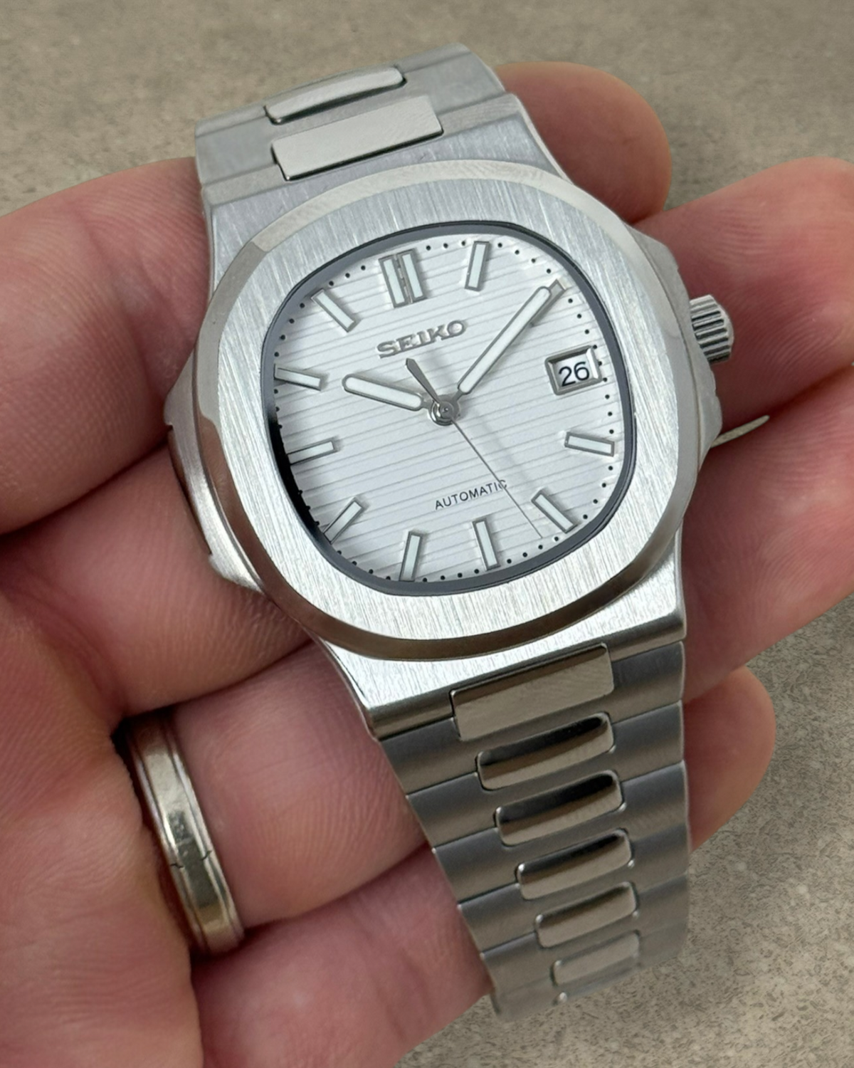 PB TimePiece Novara watch with a textured white dial, stainless steel case, and bracelet in a brushed finish.