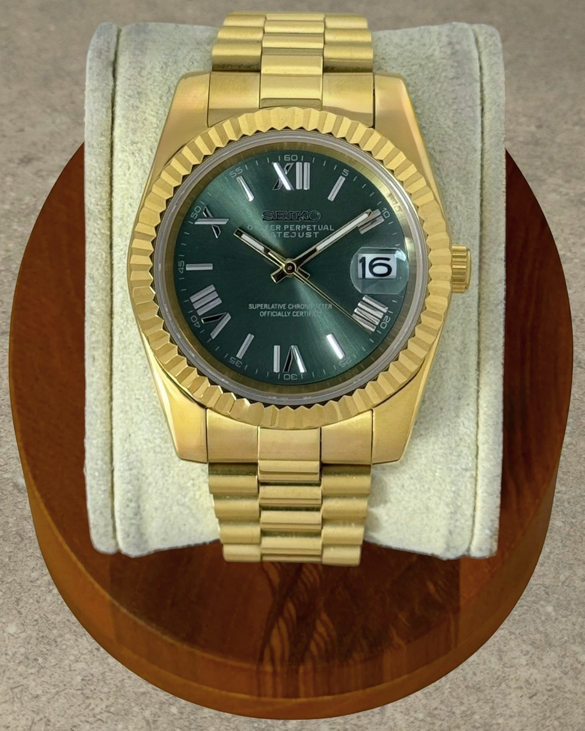 PB TimePiece Classic Date watch with an olive green dial, gold stainless steel case, and presidential bracelet.