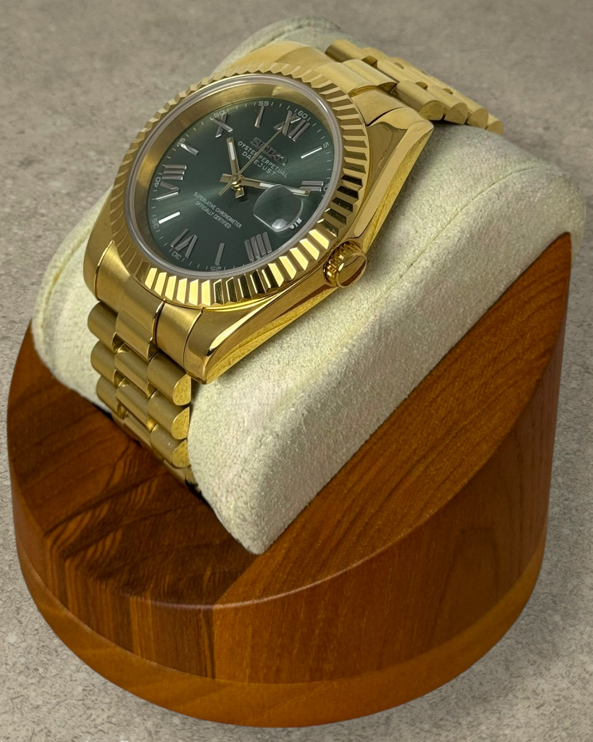 PB TimePiece Classic Date watch with an olive green dial, gold stainless steel case, fluted bezel, and bracelet.