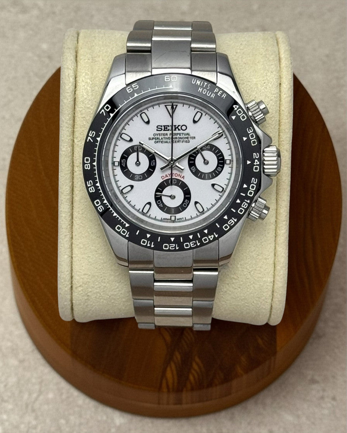 PB TimePiece Panda chronograph watch with a white dial, black bezel, and stainless steel oyster bracelet.