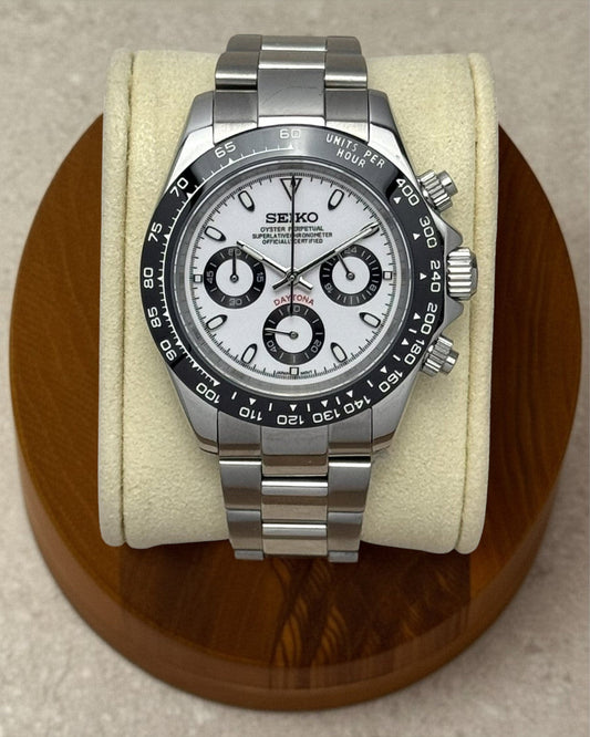 PB TimePiece Panda chronograph watch with a white dial, black bezel, and stainless steel oyster bracelet.