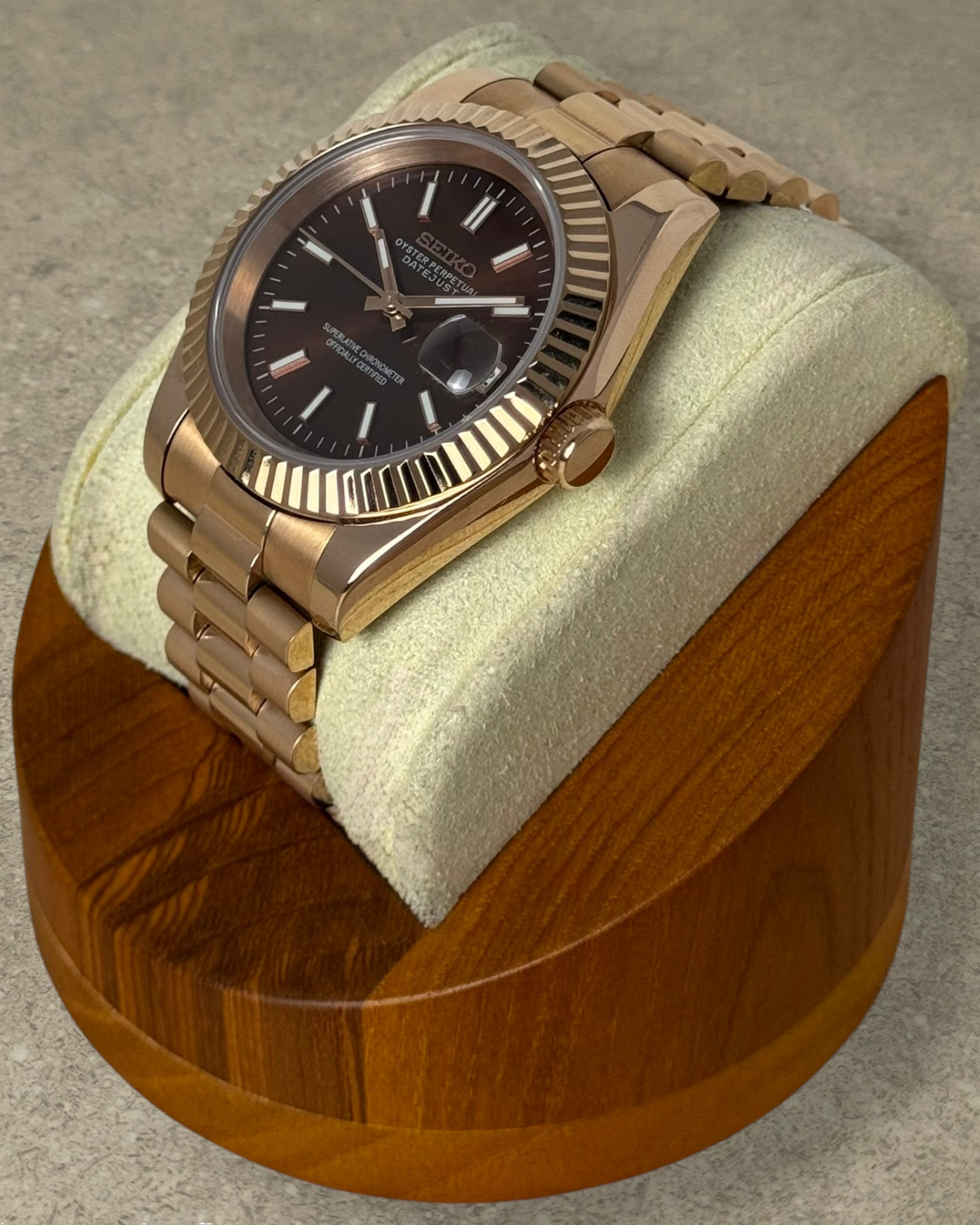PB TimePiece Classic Date watch with rose gold stainless steel case, fluted bezel, and chocolate dial on a bracelet.