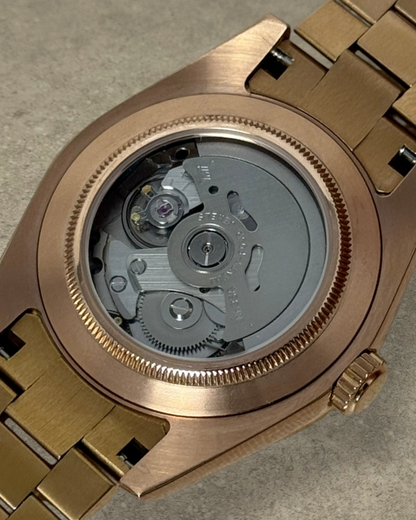 PB TimePiece rose gold watch case back showing the automatic Seiko NH35 movement and presidential bracelet