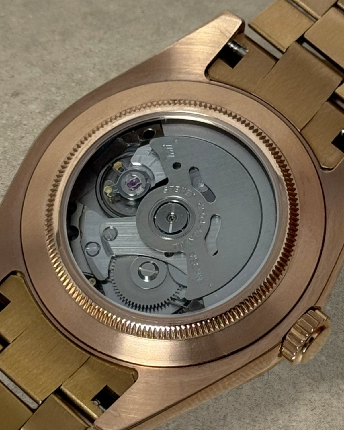 PB TimePiece Classic Date watch showing the automatic Seiko NH35 movement through the rose gold exhibition case back