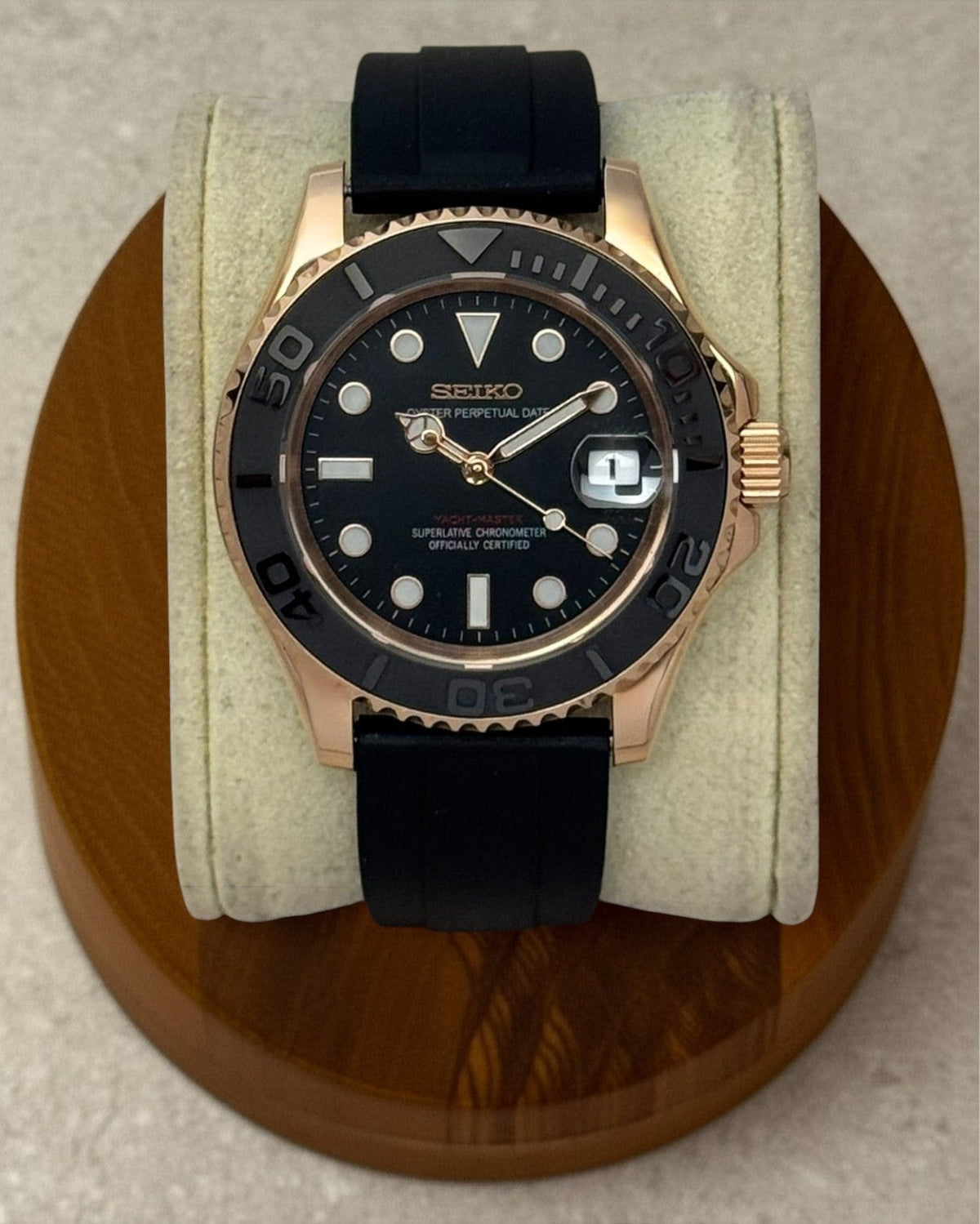 PB TimePiece Yachtmaster watch with rose gold 40mm case, black dial, rotating matte bezel, and black rubber strap.