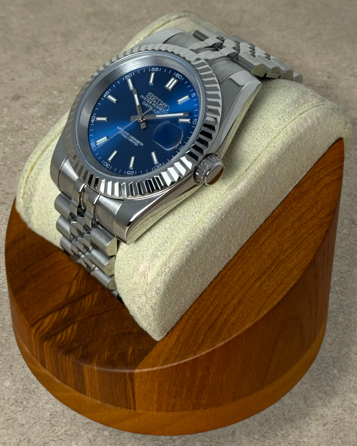 PB TimePiece Classic Date watch with a royal blue dial, stainless steel jubilee bracelet, and fluted bezel.