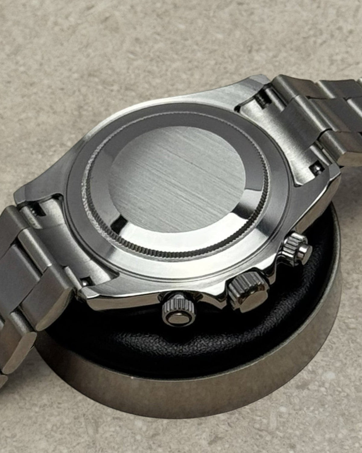 PB TimePiece Panda chronograph watch showing the brushed stainless steel case back and polished oyster bracelet