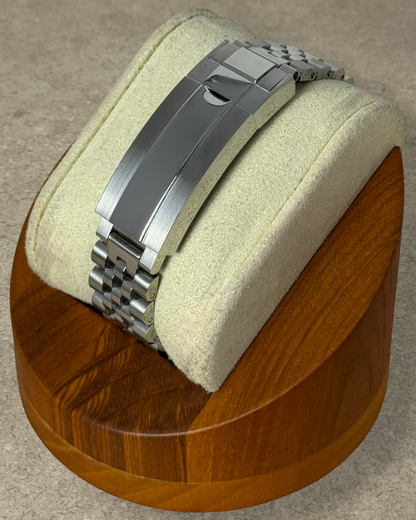 PB TimePiece stainless steel jubilee watch bracelet with micro-adjusting clasp on a wooden display stand