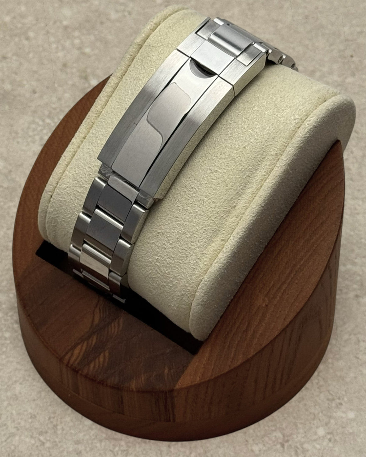 PB TimePiece stainless steel oyster bracelet with microadjusting clasp on a watch display stand