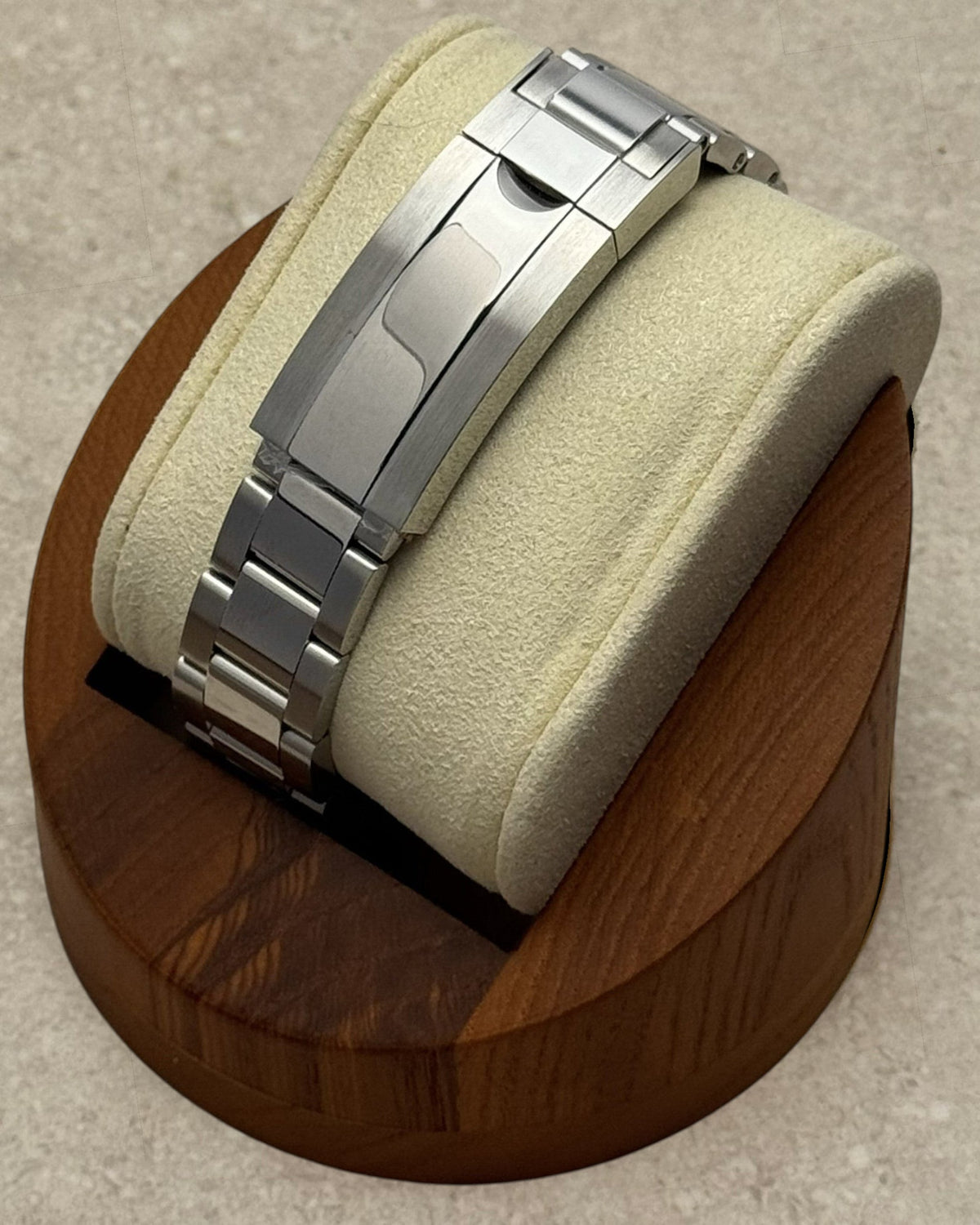 PB TimePiece stainless steel oyster bracelet with microadjusting clasp on a watch display stand