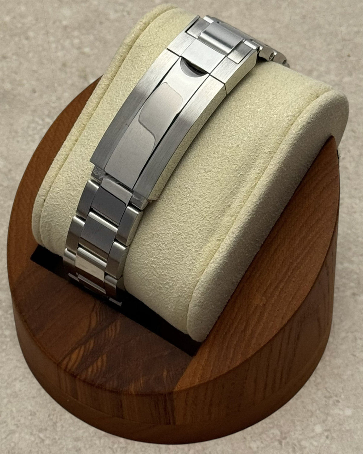 PB TimePiece stainless steel oyster bracelet with microadjusting clasp on a watch display stand