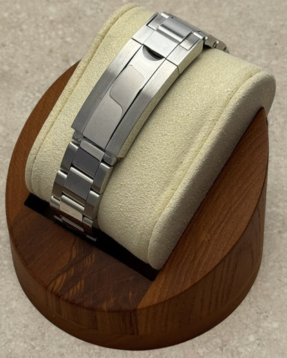 PB TimePiece stainless steel oyster bracelet with microadjusting clasp on a watch display stand
