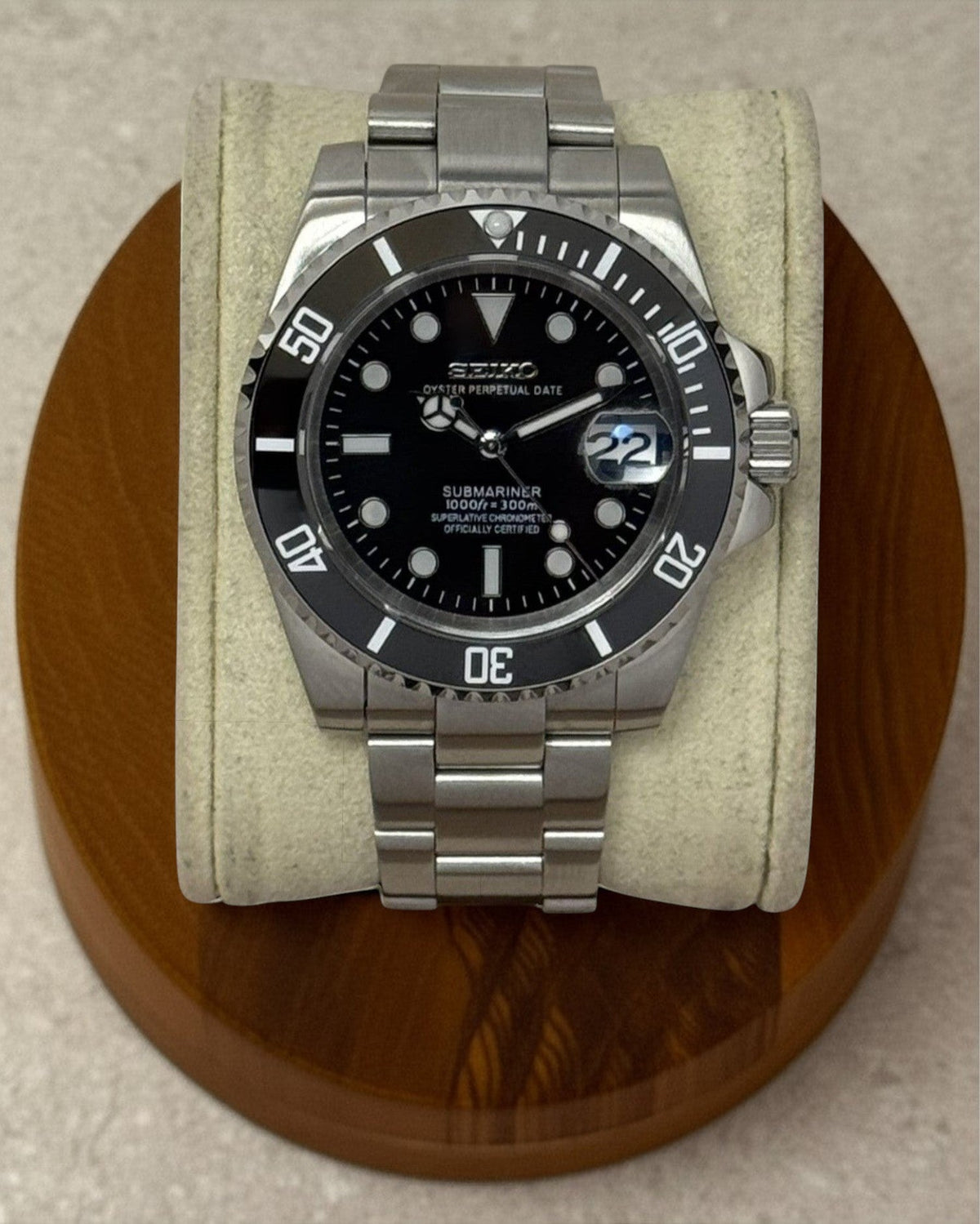 PB TimePiece Submariner watch with black dial, rotating bezel, and brushed stainless steel oyster bracelet