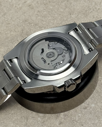 PB TimePiece Submariner Starbucks watch showing the stainless steel case back and automatic Seiko NH35 movement