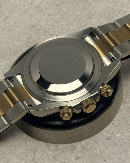 PB TimePiece two-tone gold chronograph watch showing the stainless steel case back and oyster bracelet