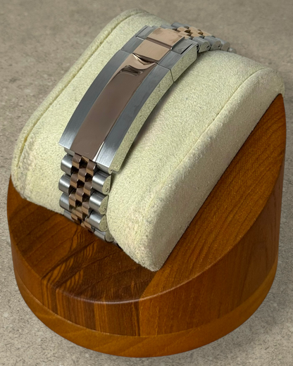 PB TimePiece two-tone rose gold and silver jubilee bracelet with microadjustable clasp on a wooden watch stand
