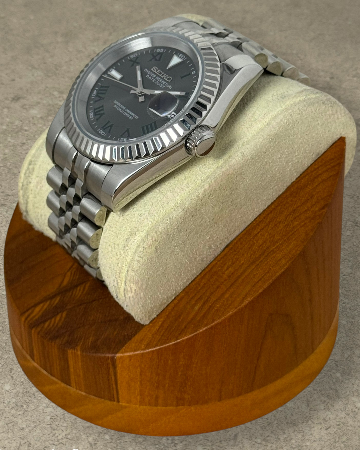 PB TimePiece Classic Date Wimbledon watch with gray dial, green Roman numerals, and stainless steel jubilee bracelet.