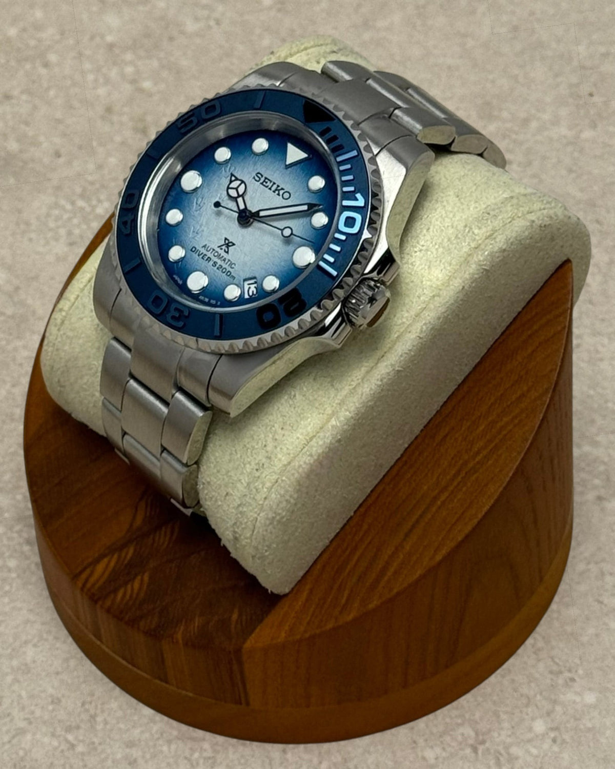 PB TimePiece Yachtmaster Save The Ocean watch with gradient blue dial, penguin footprints, and navy blue bezel.