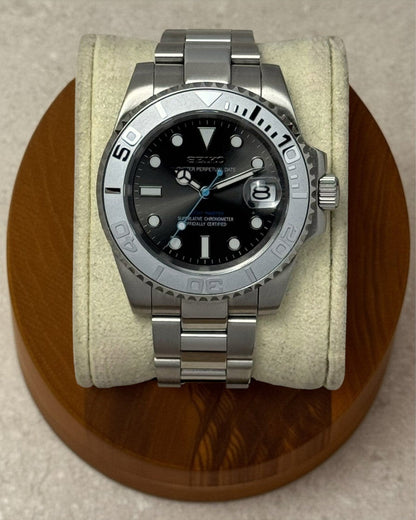 PB TimePiece Yachtmaster watch with gray dial, matte gray bezel, stainless steel case, and baby blue second hand.