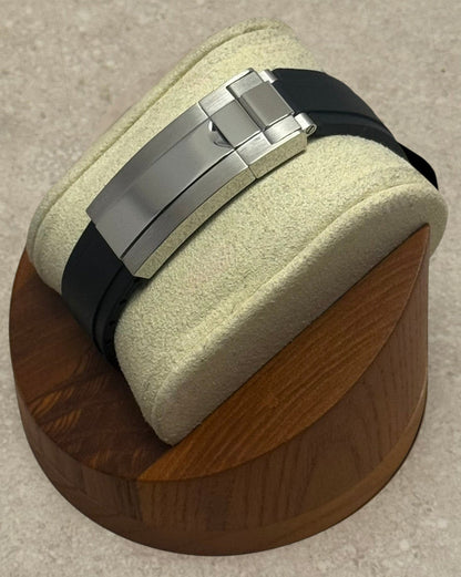 PB TimePiece Yachtmaster watch featuring a black rubber strap and stainless steel clasp on a display stand