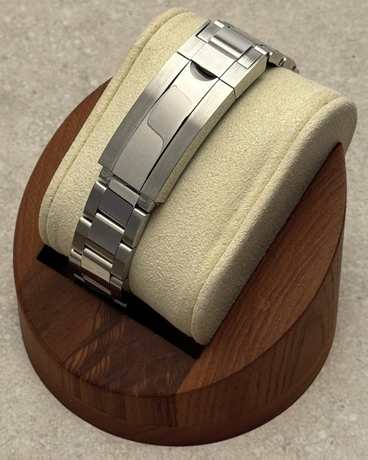 PB TimePiece Yachtmaster watch stainless steel oyster bracelet clasp detail on a wooden display stand