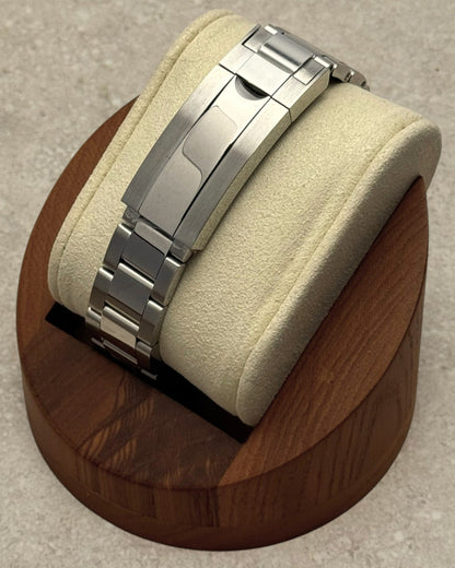 PB TimePiece Yachtmaster watch stainless steel oyster bracelet clasp detail on a wooden display stand